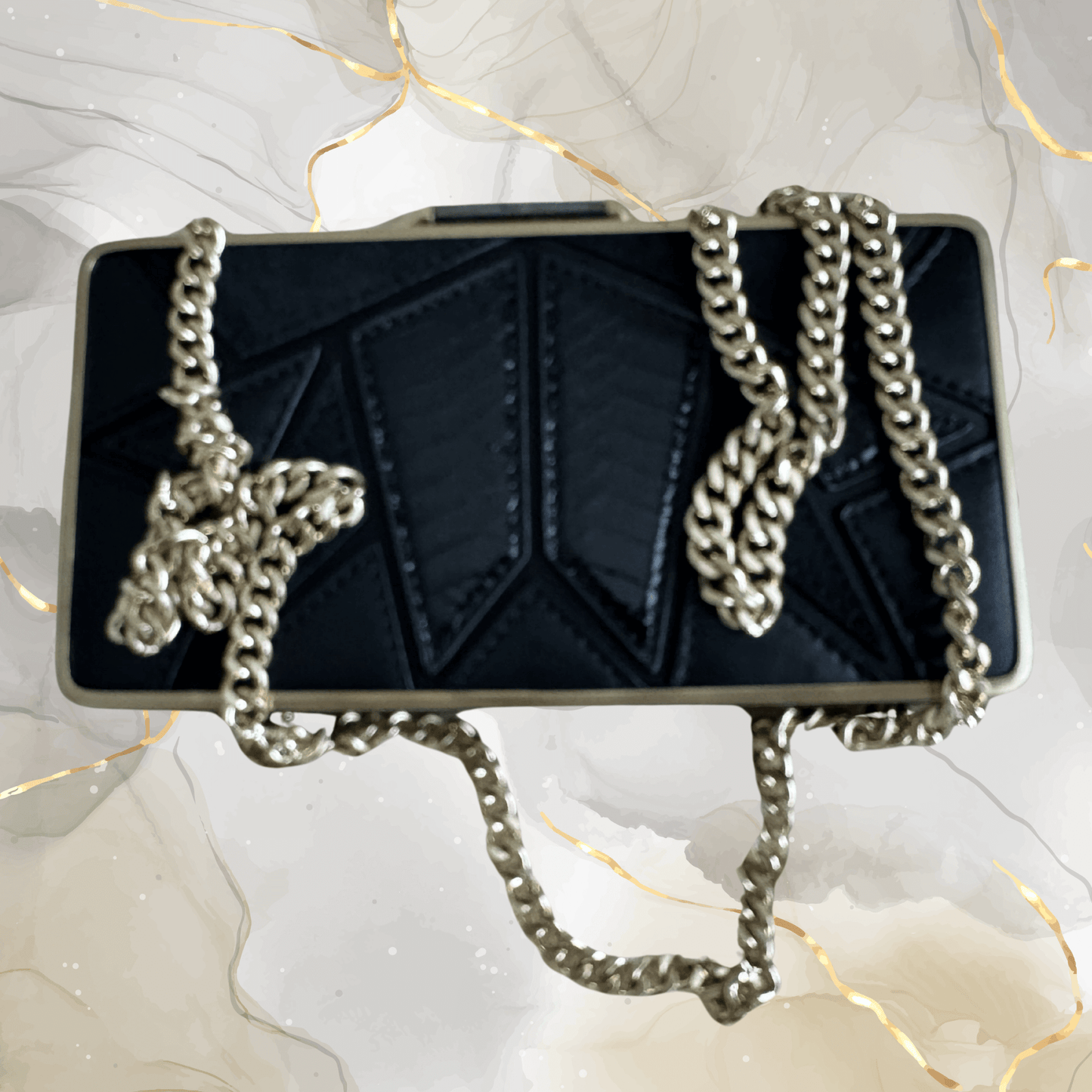 Preowned Brian Atwood black leather clutch with gold frame and chunky chain strap, perfect for evening events.